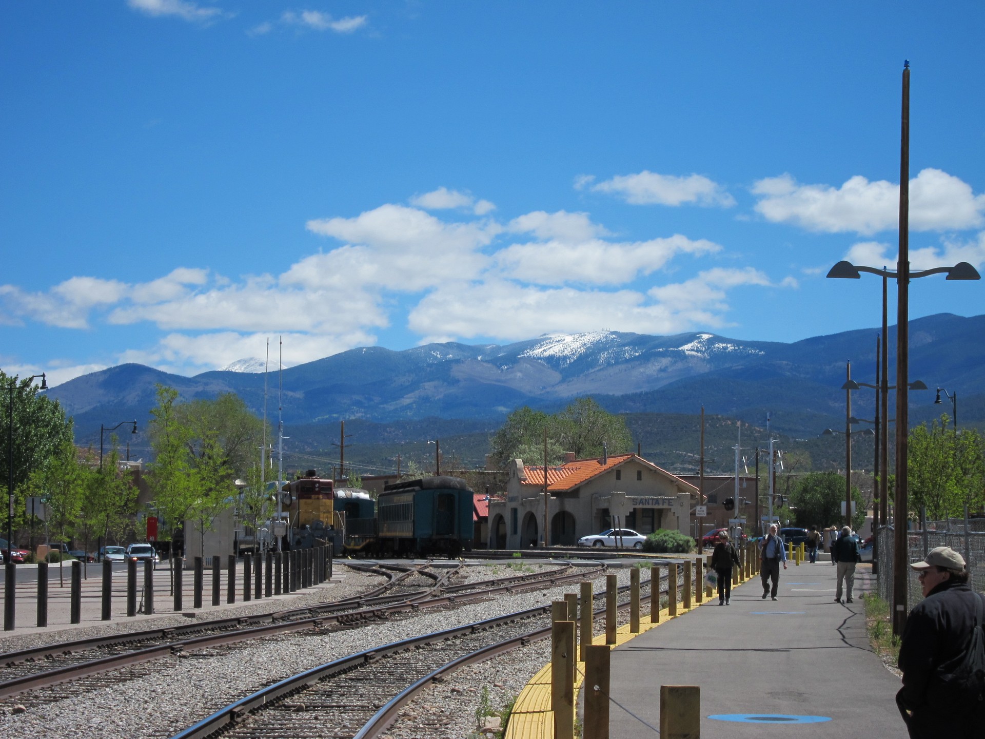 Snow-capped mountains rising behind the historic Santa Fe railyard and adobe train depot